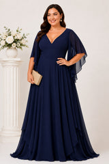 Front view of the Nala navy blue plus size formal chiffon maxi dress with V-neckline, angel sleeves and flowing layered skirt.