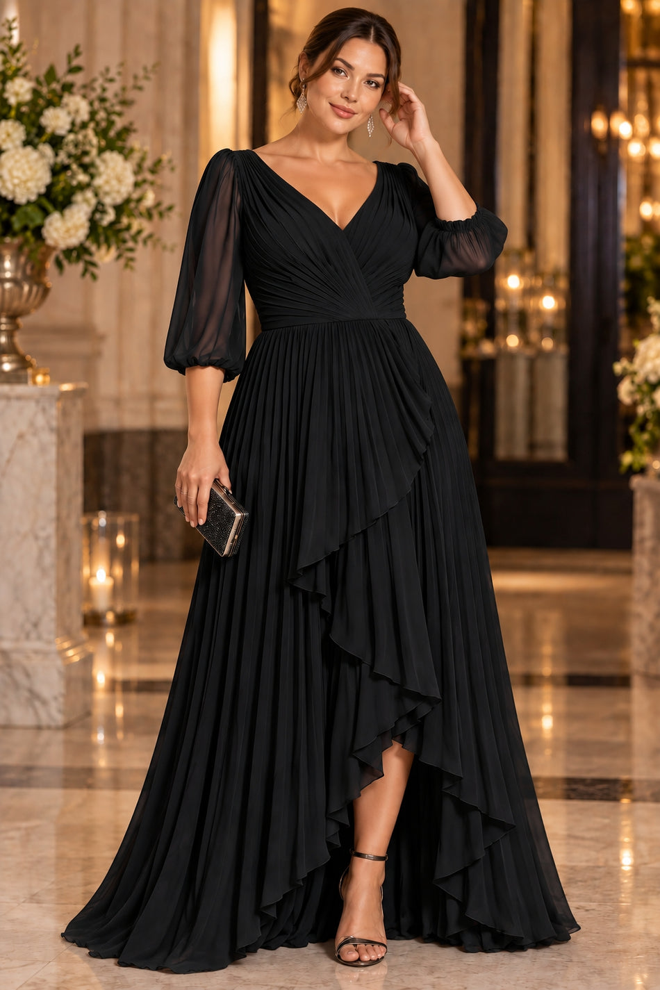 Plus size woman wearing a black maxi evening dress with pleated V-neck bodice, sheer three-quarter sleeves and cascading layered front.