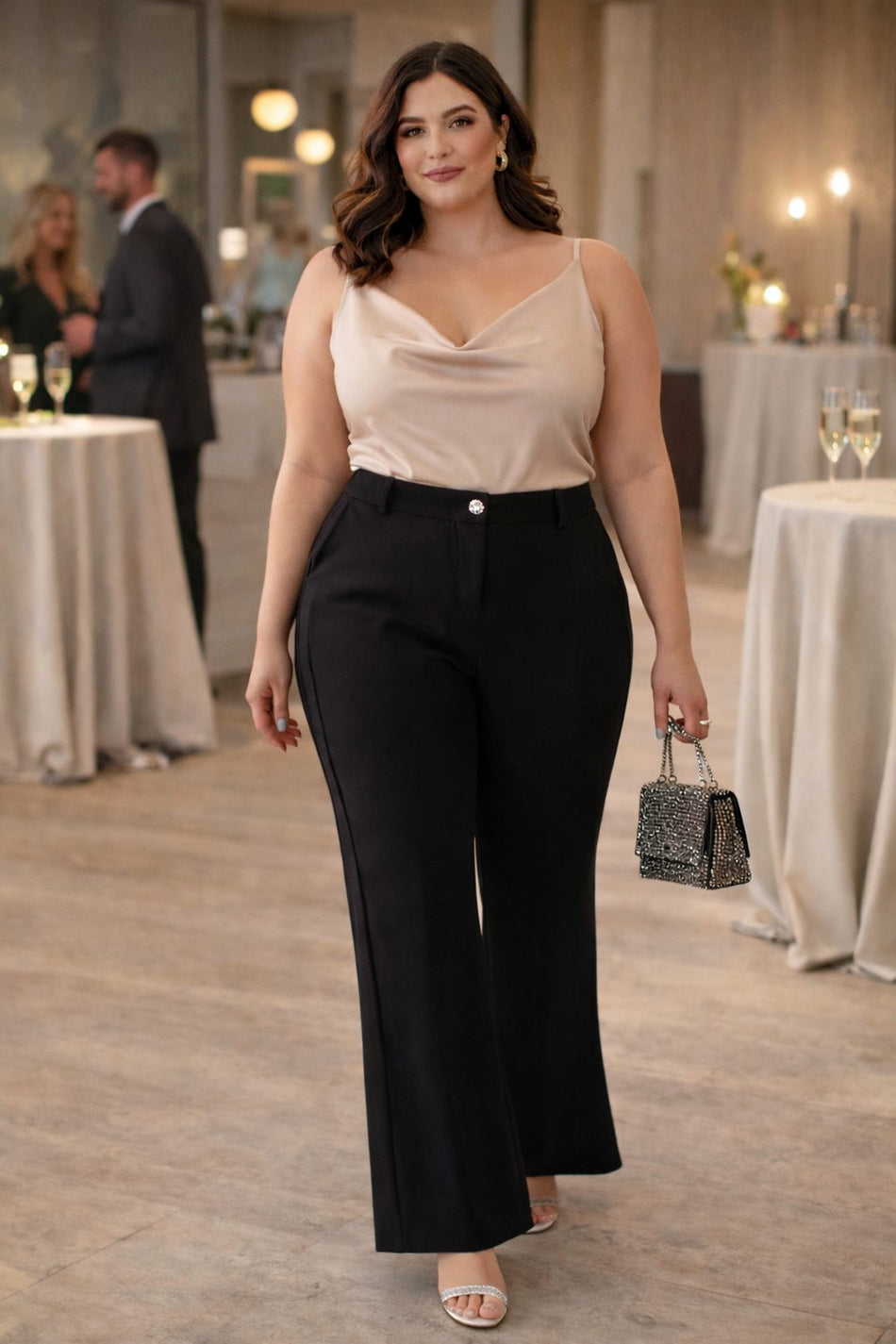 Plus size model wearing black bell bottom trousers cocktail outfit front view evening styling