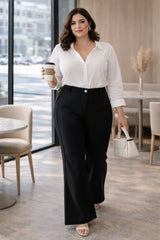 Plus size model wearing black bell bottom trousers work outfit front view office styling