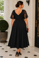 Back view of a plus size black cocktail midi dress featuring a V-back neckline and lace flutter sleeves.