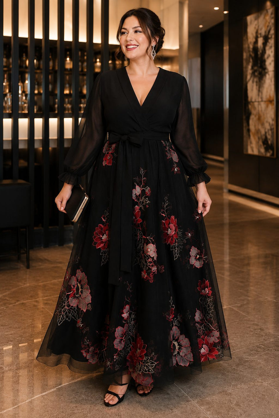 Plus size black floral evening dress with sheer long sleeves, flattering V-neckline, raised waist and flowing A-line skirt front view.