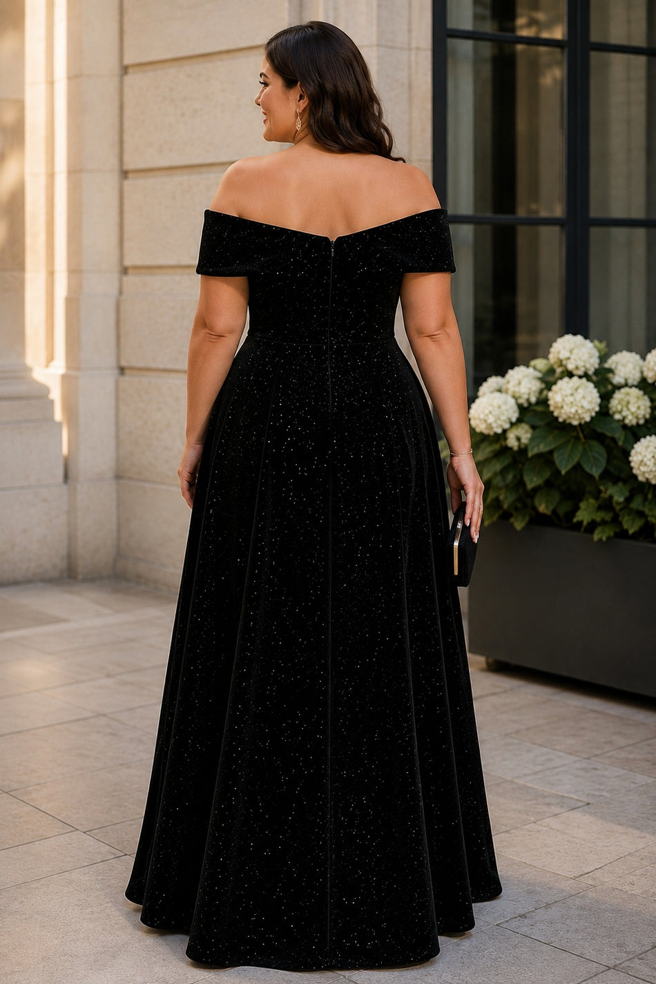 Back view of a plus size black off-shoulder evening dress with shaped neckline, defined waist and sweeping A-line skirt.