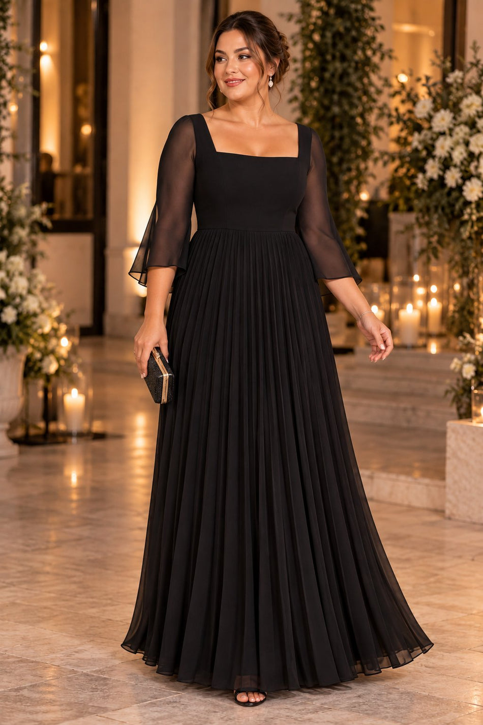Woman wearing a black plus size formal dress with a square neckline, sheer flutter sleeves and floor-length pleated skirt.