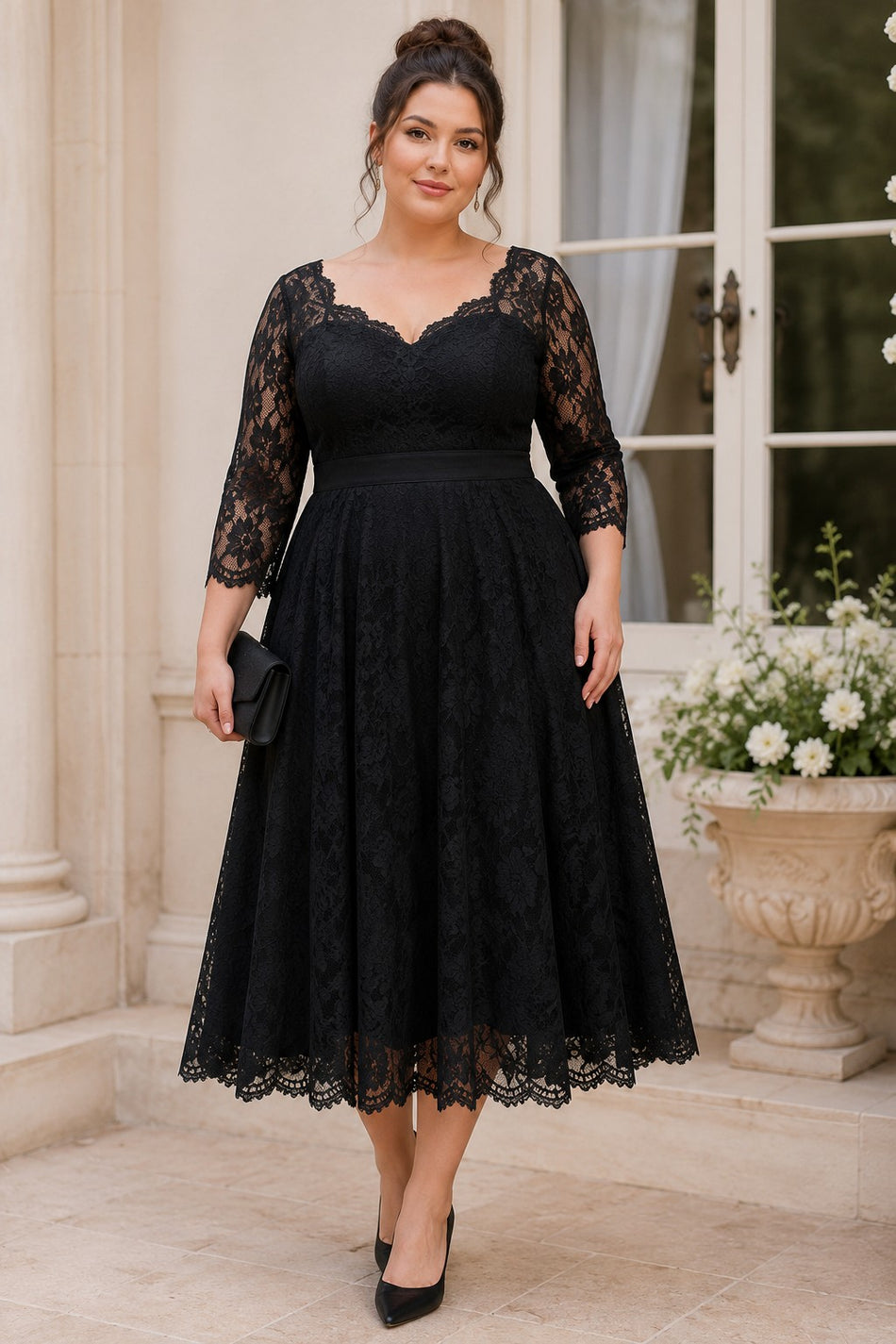 Plus size woman wearing a black lace midi cocktail dress with three-quarter sleeves, defined waistband and full A-line skirt.
