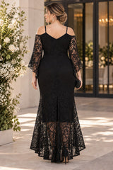 Back view of a plus size black lace evening dress with slim straps, cold-shoulder lace sleeves and a gently flared full-length skirt.