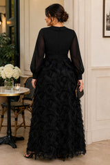Back view of a plus size black evening maxi dress with long sheer sleeves, defined waistband and full textured A-line skirt.