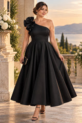 Plus size woman wearing a black one shoulder cocktail midi dress with statement shoulder detail and full A-line skirt.
