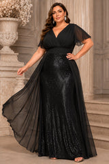 Plus size black sequin evening gown with chiffon overlay, flutter sleeves and flattering wrap V-neck front view