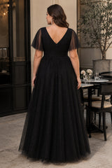 Back view of a plus size black sparkle formal dress with elegant V-back, flutter sleeves and flowing full-length skirt.