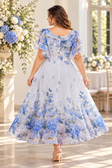 Back view of a blue floral wedding guest dress with flutter sleeves, fitted waist and flowing A-line skirt.