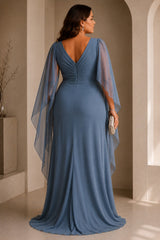 Back view of a plus size blue maxi formal dress with V-shaped back, gathered bodice and flowing sheer cape sleeves.