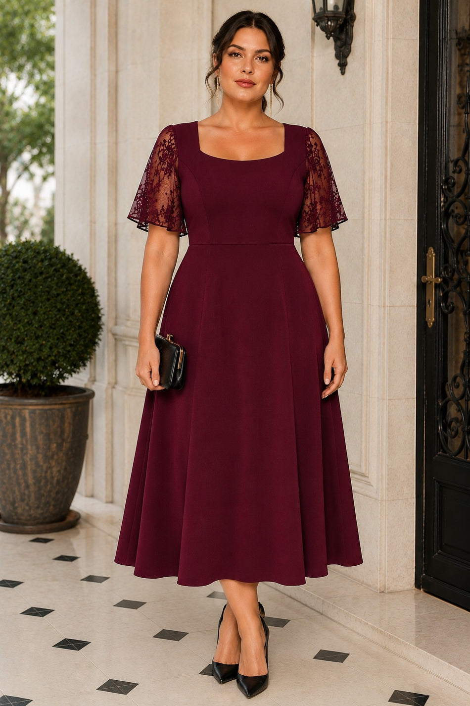Plus size woman wearing a burgundy A-line cocktail dress with square neckline and sheer lace flutter sleeves.