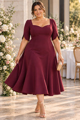 Plus size burgundy A-line midi cocktail dress with square neckline and petal sleeves, front view.