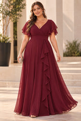 Plus size woman wearing a burgundy chiffon evening dress with wrap V neckline, flutter sleeves and cascading front drape.
Burgundy — Back