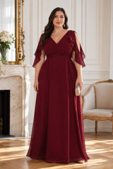 Front view of a plus size burgundy formal dress with crossover V-neck, cold shoulder flutter sleeves and flowing maxi skirt.