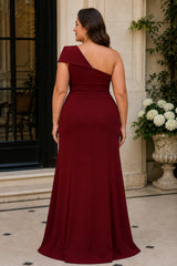 Back view of plus size burgundy one shoulder formal dress with asymmetric neckline and floor-length skirt.