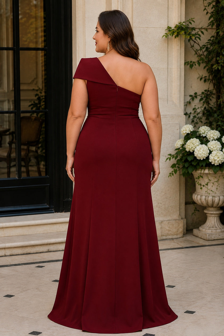 Back view of plus size burgundy one shoulder formal dress with asymmetric neckline and floor-length skirt.