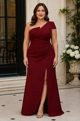 Plus size burgundy one shoulder formal dress with diagonal waist draping and front split, front view.