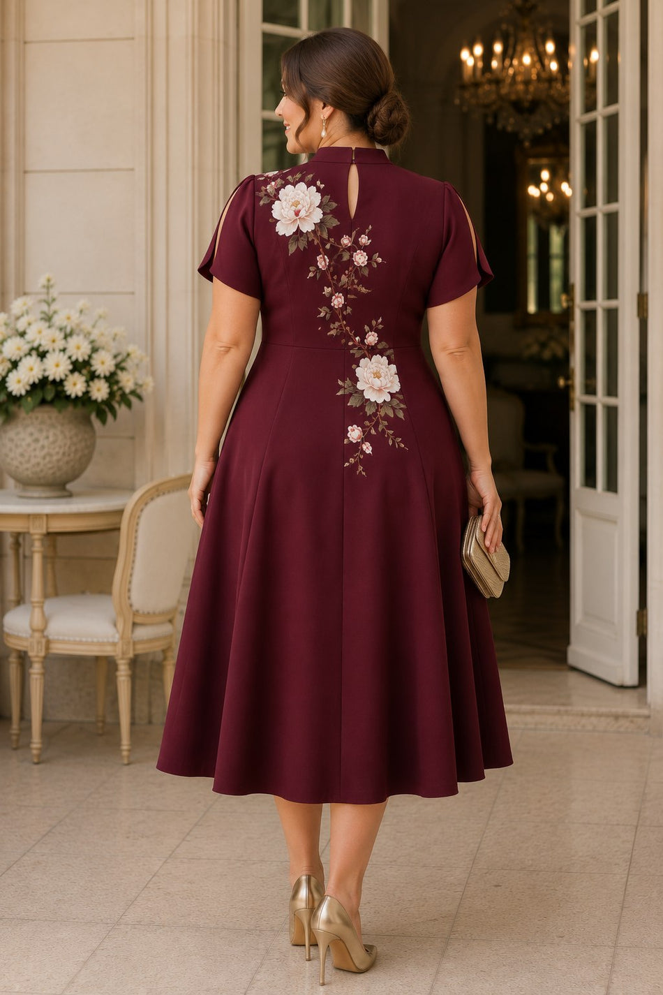 Back view of a plus size burgundy Oriental-inspired wedding guest dress with elegant peony floral artwork, mandarin collar and keyhole back detail.