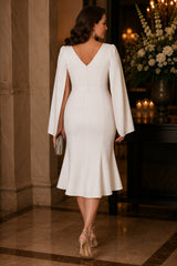 plus size white cape sleeve cocktail midi dress with wrap V-neckline and fluted skirt front view.