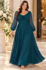 Plus size woman wearing a teal formal maxi dress with a draped cowl neckline, sheer long sleeves and flowing A-line skirt.