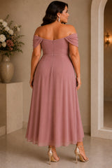 Back view of a plus size dusty mauve off shoulder midi cocktail dress with a softly flowing A-line skirt