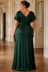 Back view of a plus size emerald green evening dress with flutter sleeves, wrap V-neckline, draped waist and flowing floor-length skirt.