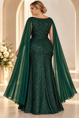 Back view of a plus size emerald green sequin evening gown with wide neckline and long sheer cape sleeves.