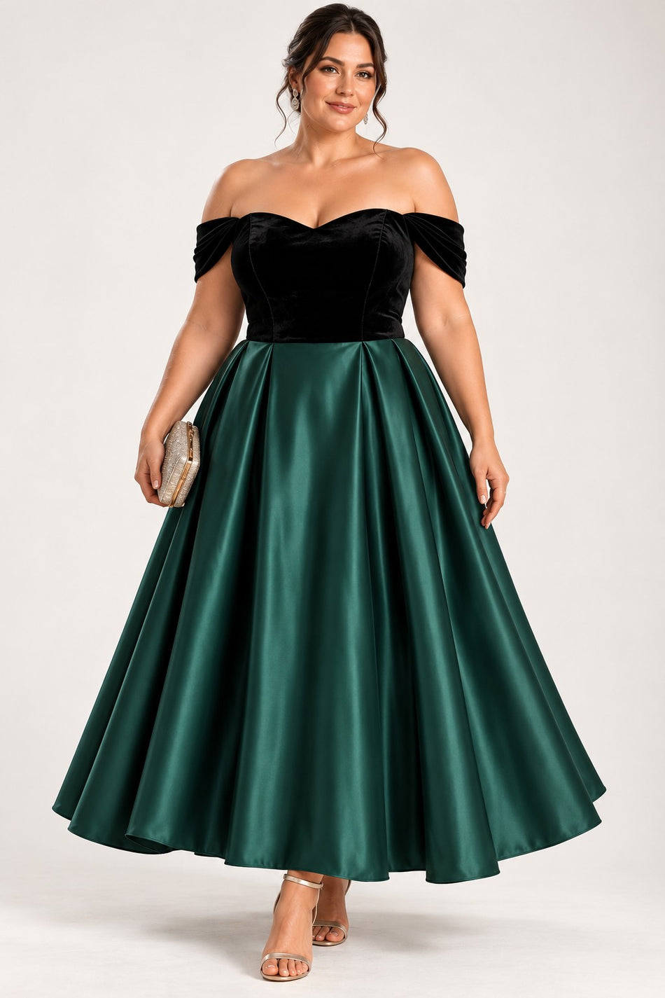 Plus size woman wearing an emerald green midi dress with a fitted black bodice, sweetheart off-shoulder neckline and full A-line skirt.