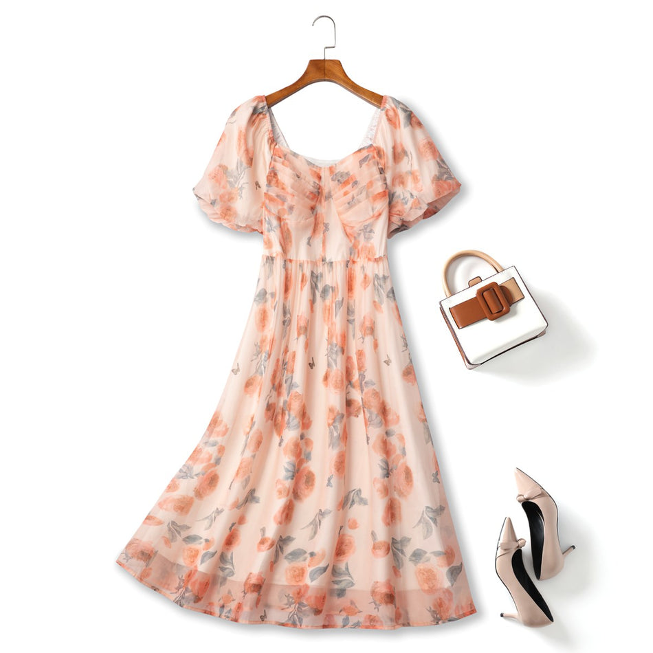 Plus size peach floral midi dress with puff sleeves and shirred bodice