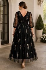 Back view of Annelise Plus Size Floral Wedding Guest Midi Dress in Black featuring a V-back, floral embroidery and sheer sleeves.