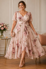 Plus size blush floral wrap midi dress with flutter sleeves and flowing handkerchief hem for wedding guests