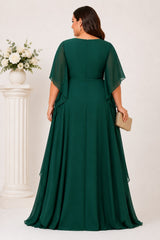 Back view of an emerald green plus size chiffon formal maxi dress with flowing angel sleeves and layered maxi skirt.