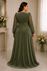 Back view of a plus size green formal wrap maxi dress with long sheer sleeves, softly gathered waist and flowing floor-length skirt.