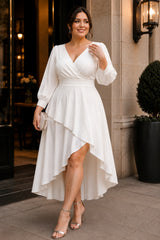 Front view of an ivory plus size wedding guest dress with wrap neckline and high-low skirt.