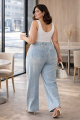 Plus size model wearing light blue pearl wide leg jeans back view high waist relaxed fit