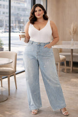 Plus size model wearing light blue pearl wide leg jeans front view high waist curve fit
