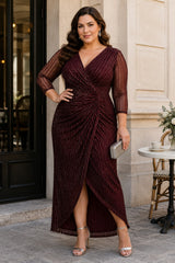 Plus size woman wearing a burgundy wrap midaxi formal dress with V-neck, gathered waist and sheer 3/4 sleeves.