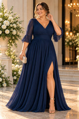 Plus size woman wearing a navy chiffon formal maxi dress with wrap V-neck, 3/4 flutter sleeves and flowing skirt.