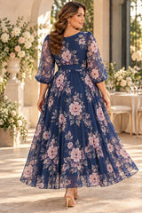 Back view of a navy floral maxi dress with sheer three-quarter sleeves, a wide navy waistband and a flowing ankle-length skirt.