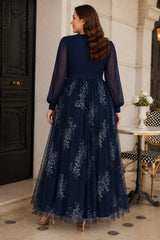 Back view of a plus size navy floral evening dress with sheer long sleeves, defined waistband and flowing full-length skirt.