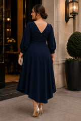Back view of a navy plus size wedding guest dress with elegant high-low hem and three-quarter sleeves.
