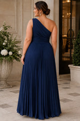 Back view of a plus size navy one shoulder formal dress with an asymmetric neckline, defined waist and floor-length pleated skirt.