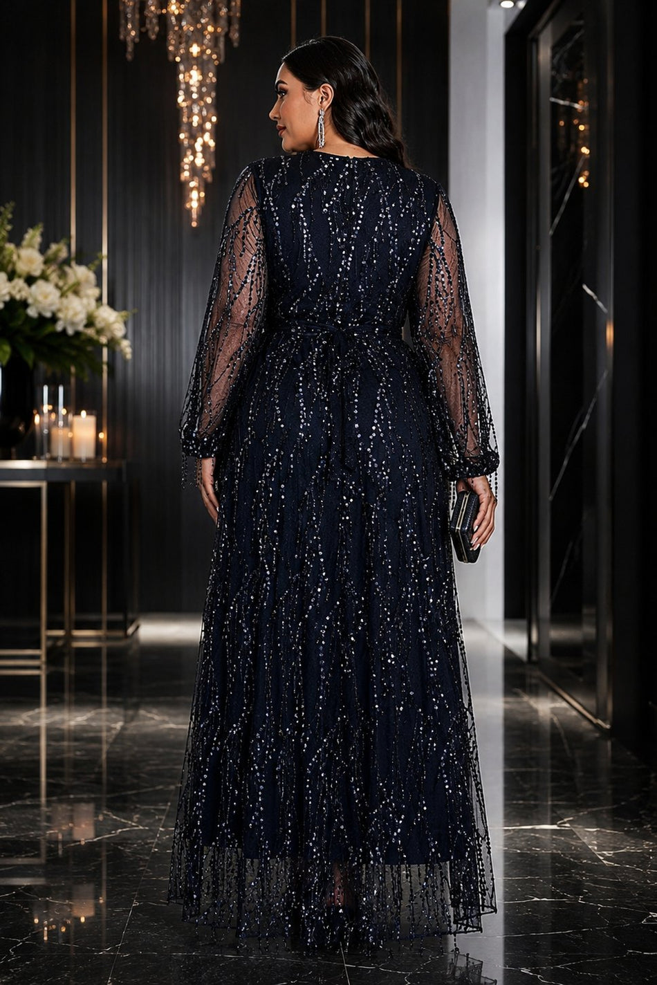 Back view of plus size navy sequin evening maxi dress with sheer embellished sleeves and flowing full-length skirt.