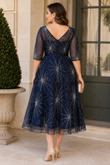 Back view of a plus size navy sparkle wedding guest dress featuring a V-shaped back neckline, elegant three-quarter sleeves and a flowing A-line midi skirt.