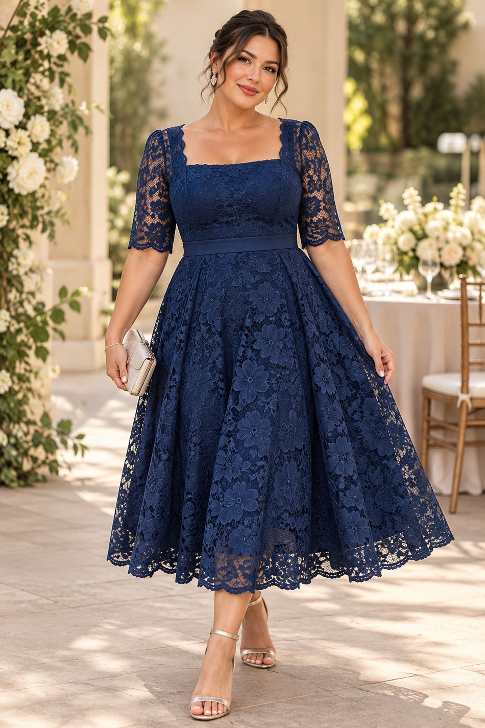 Plus size woman wearing a navy floral lace square neck midi wedding guest dress.