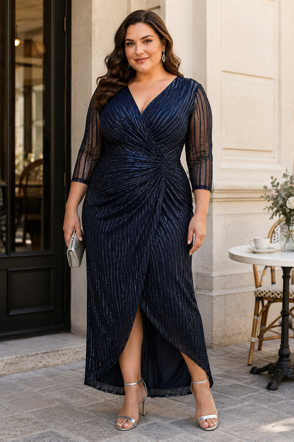 Plus size woman wearing a navy wrap midaxi formal dress with V-neck, gathered waist and sheer 3/4 sleeves.