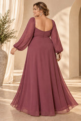 Back view of a dusty rose pink plus size evening maxi dress with low square back, long sheer sleeves and flowing A-line skirt.