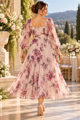 Back view of plus size pink floral tea-length dress with square back, three-quarter sleeves and ruched waist.